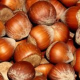 A whole image full of golden brown ripe hazelnuts in their shells
