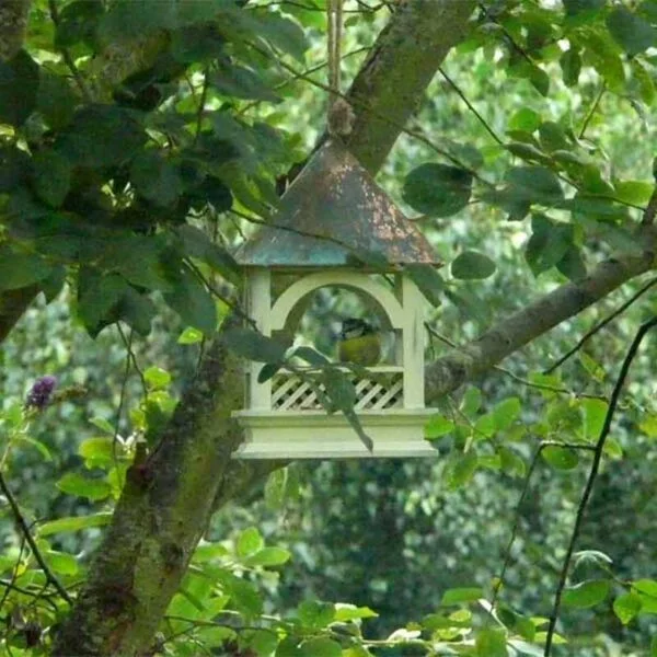 Bempton Bird Hanging Table hanging amid branches in a tree