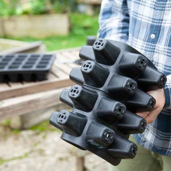 20 cell rubber seed tray being bent to show the underside of the cells and that it is made of rubber and therefore flexible