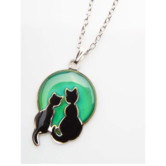 cats & moon pendant, the cats are facing the moon and are in black, the moon is green