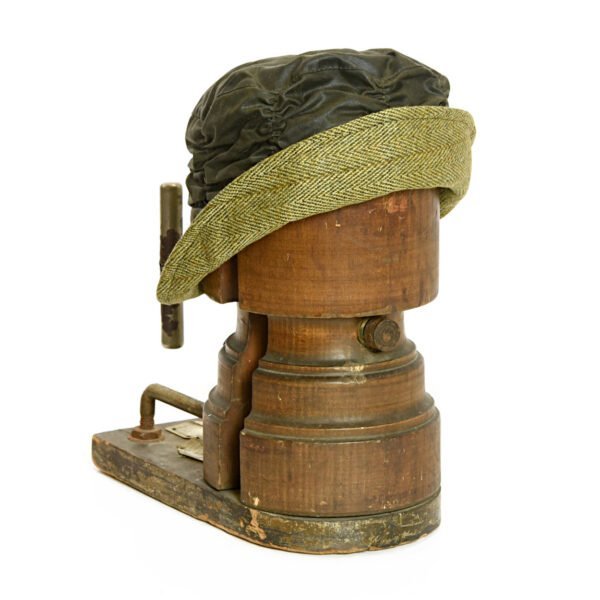 Tweedmill green wax cloche with olive green tweed brim on an old wooden hat form