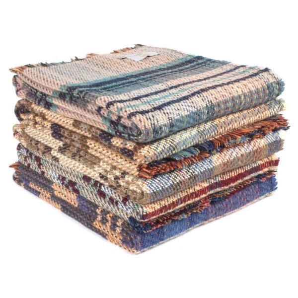 Recycled Wool Rug by Tweedmill with random colours in a pile angled view