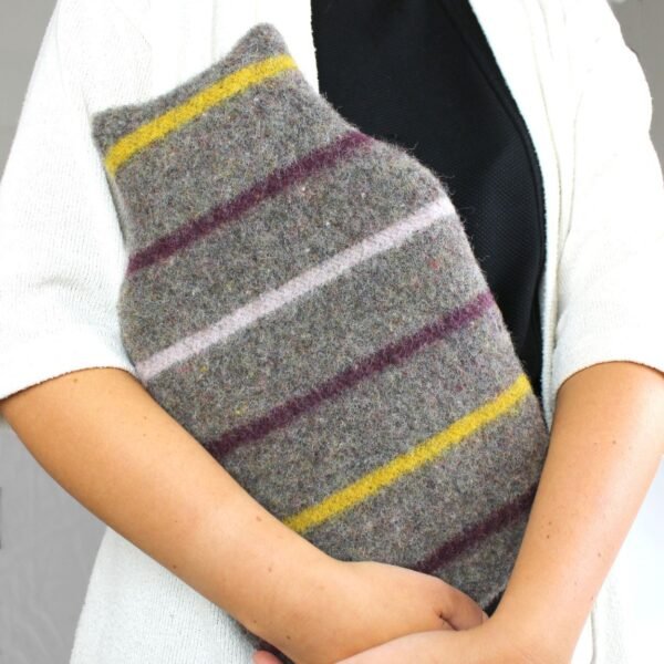 Tweedmill middle opening recycled wool hot water bottle and cover with grey background with yellow, white and purple stripes