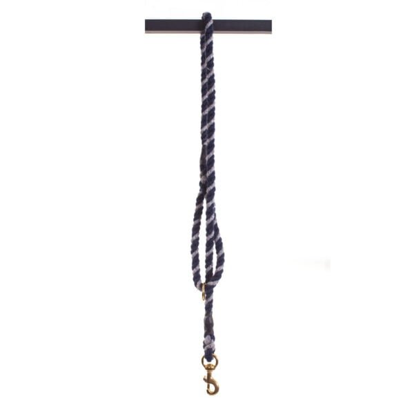 Navy Blue and Silver Grey Tweedmill wool rope dog lead hanging in half over a pole on a white background