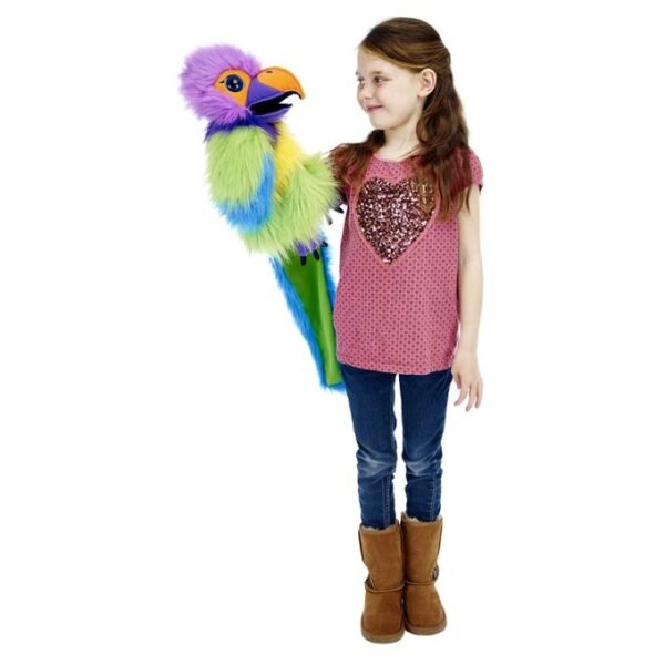 Plum-headed Parakeet by The Puppet Company in green, blue, yellow, and purple long hair fur with purple feet and black claws being held by a young girl in a purple top and jeans