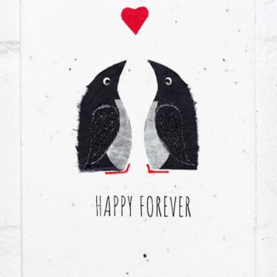 Two penguins below a heart with the text Happy Forever at the bottom on a textured plantable greeting card