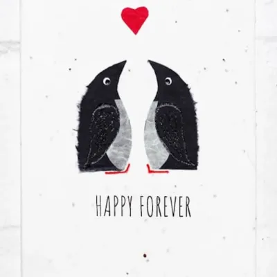 Two penguins below a heart with the text Happy Forever at the bottom on a textured plantable greeting card