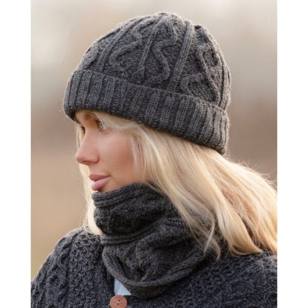 Merino wool hat in Aran knit Slate Grey worn by a woman outdoors